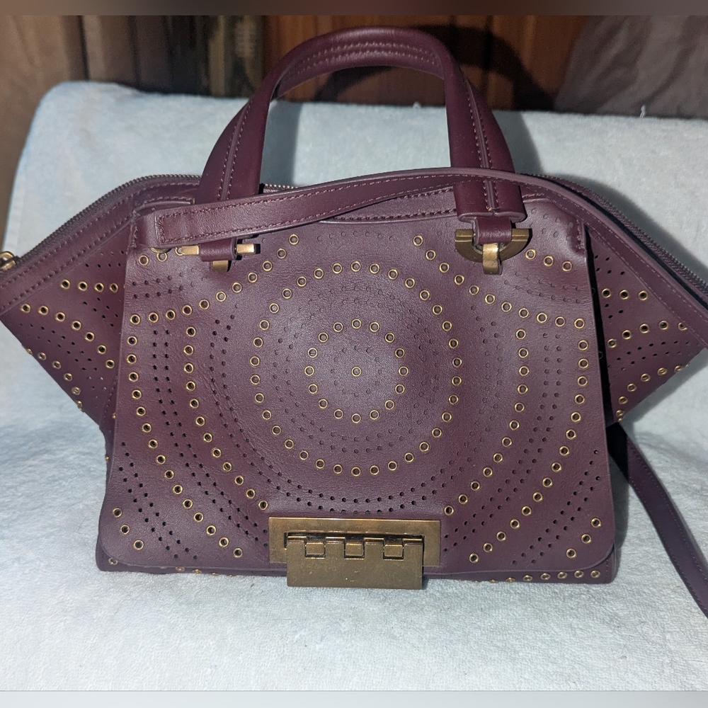 Zac Posen laser cuts crossbody bag.